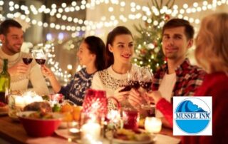 mussel inn £5 off voucher - people dining and clinking glasses in a festively decorated room