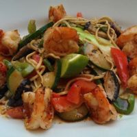 Stir fried tiger prawns with egg noodles, veg, shitake mushrooms and pak choi in Thai green coconut sauce with ginger and garlic